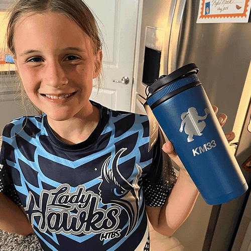 A softball player holding a bottle with her logo